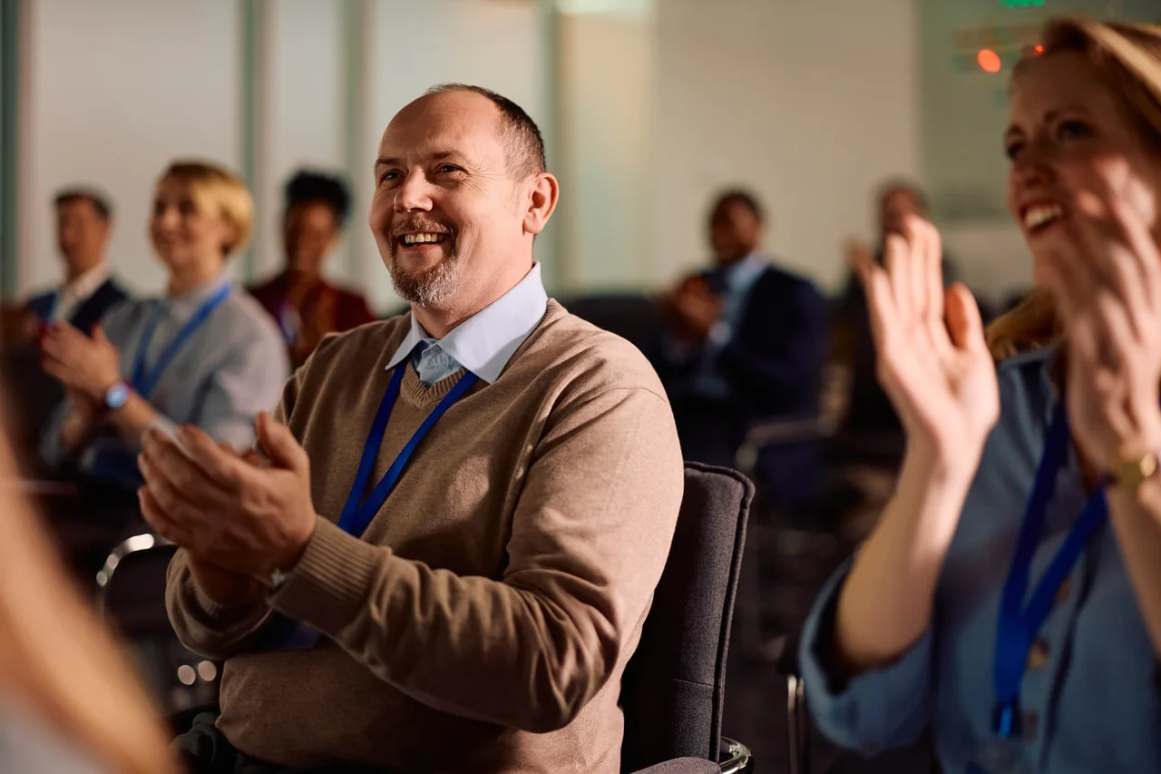 Business event attendees applauding